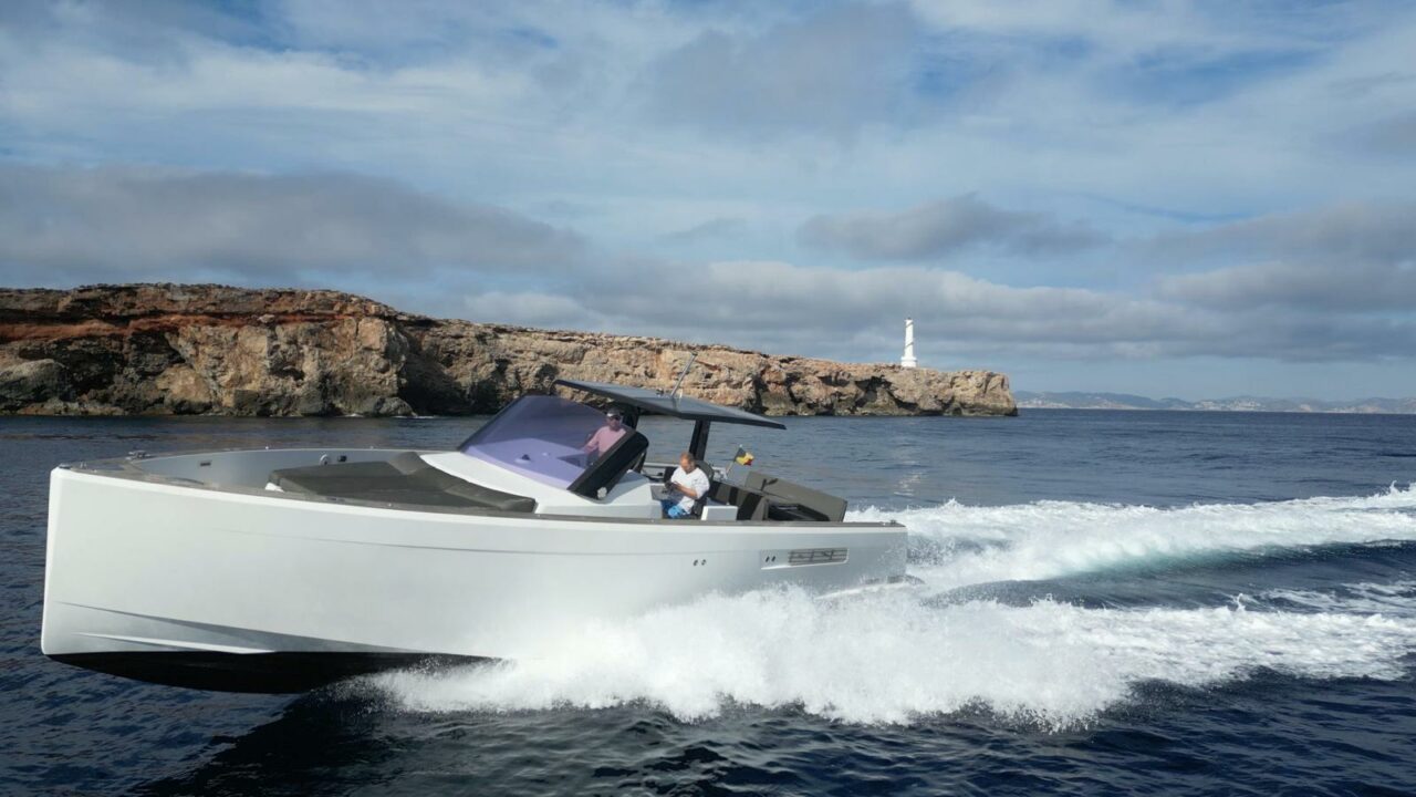 Fjord 40 Open side profile beneath coastal cliffs